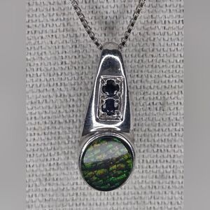 Sterling silver pendant necklace featuring an oval Australian opal and Sapphires